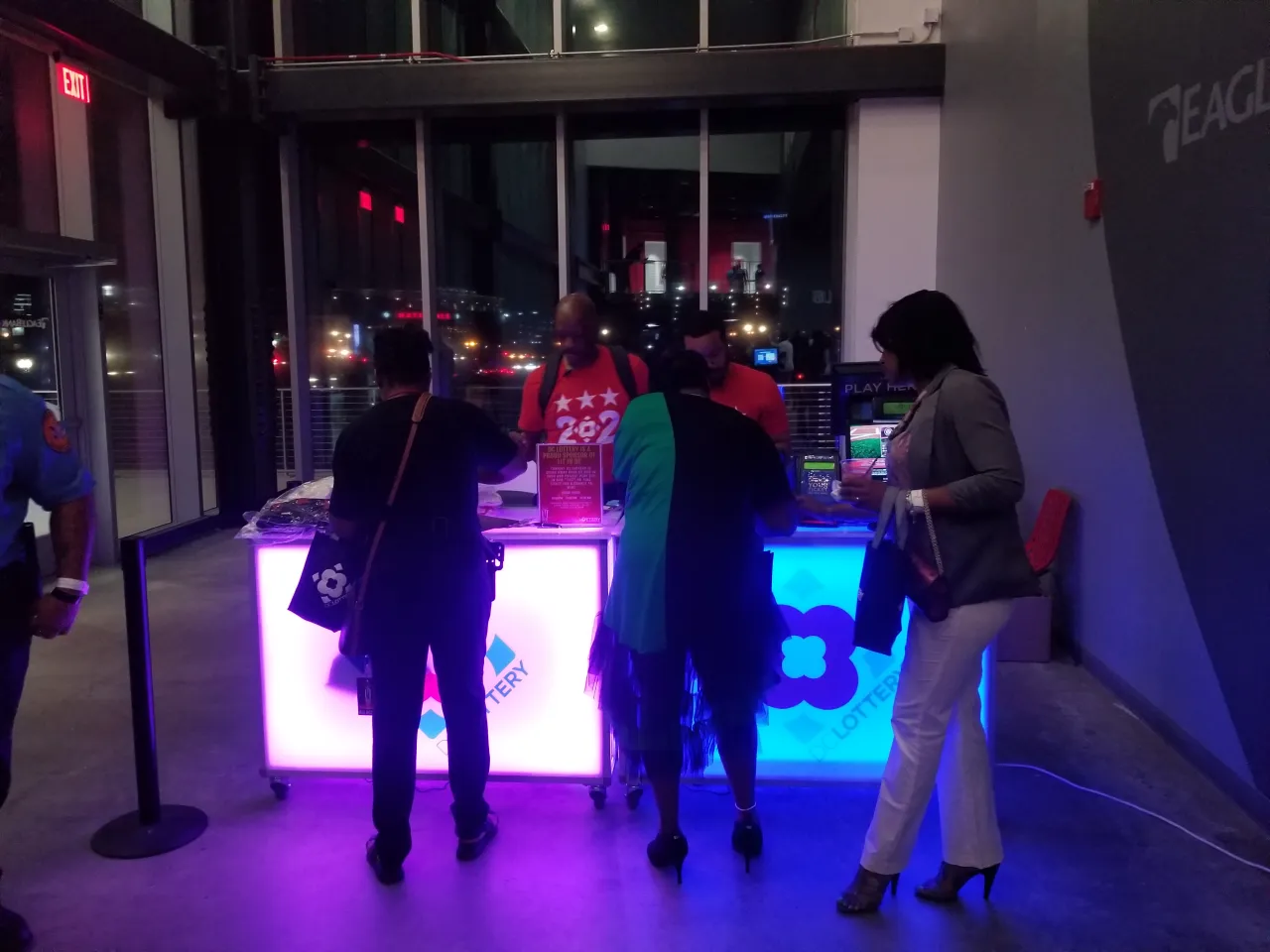 players waiting to purchase tickets at kiosk