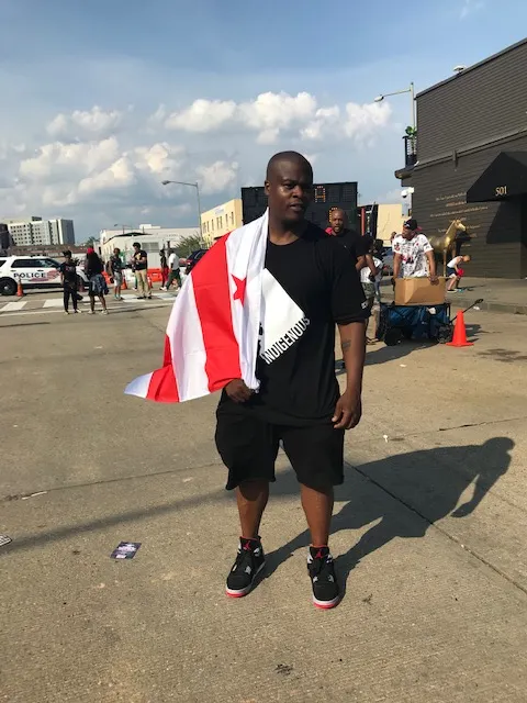 Tony Lewis Jr draped in DC flag