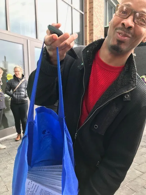 man holding a bag of scratch tickets