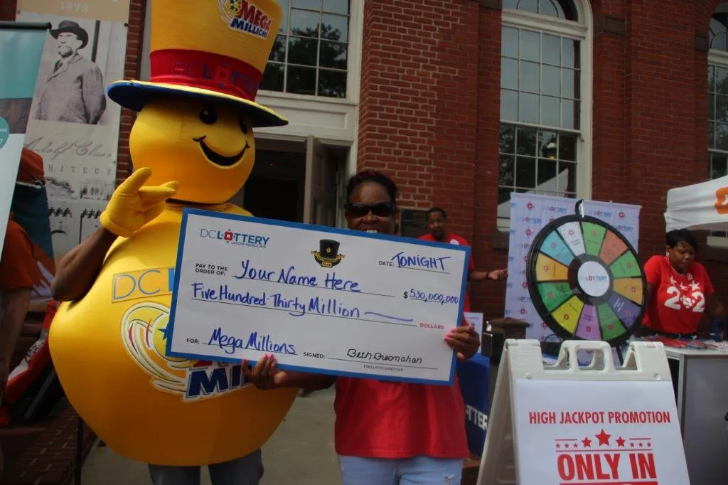 Mega Millions mascot holding large check