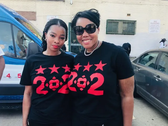two women wearing 202 shirts