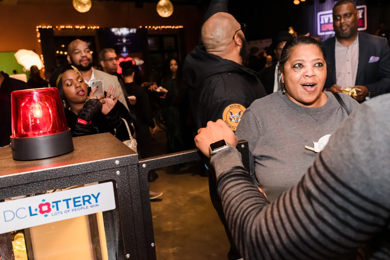 Woman opening DC Lottery Cash Vault game