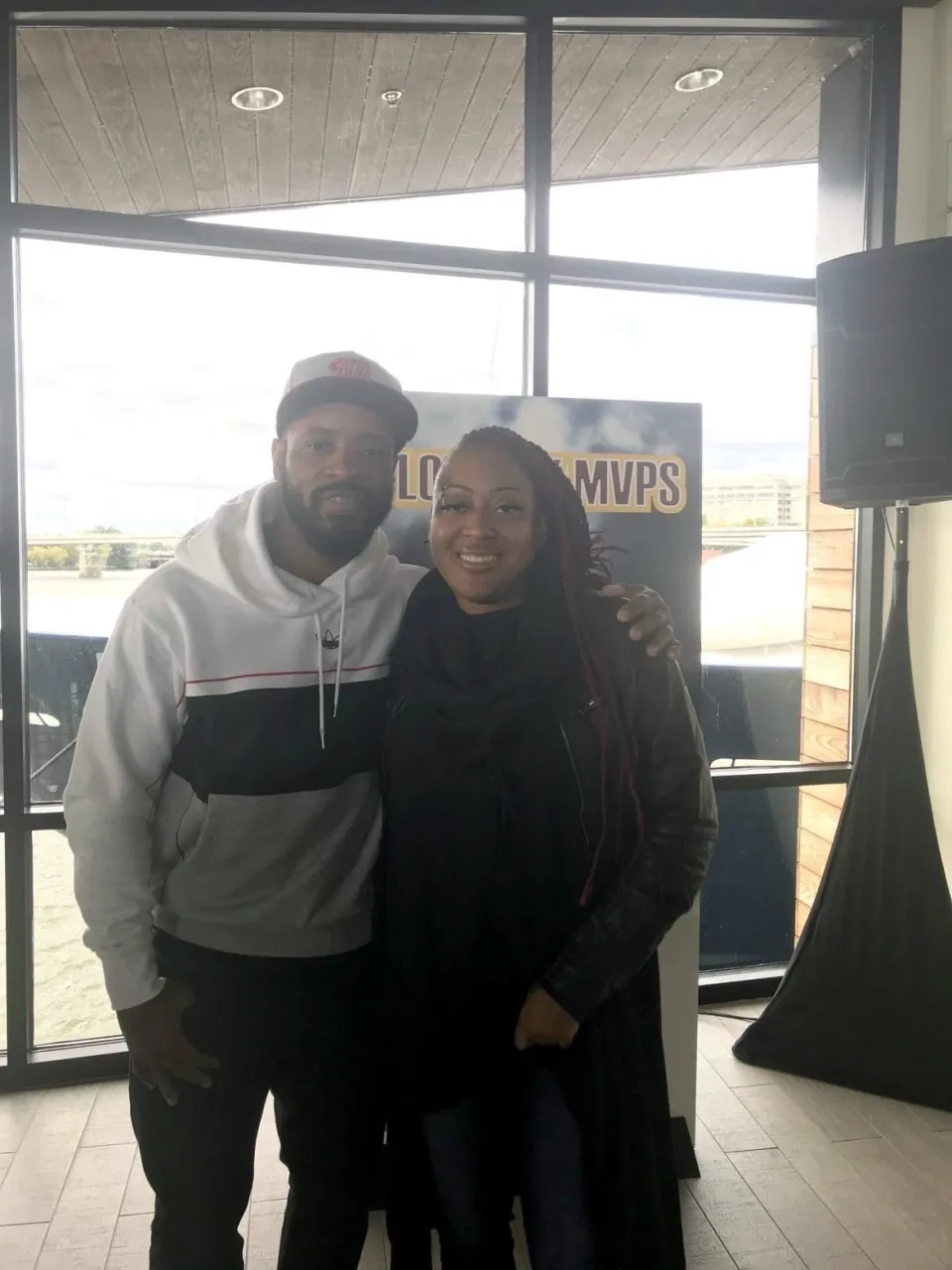 Santana Moss posing for a photo with a player